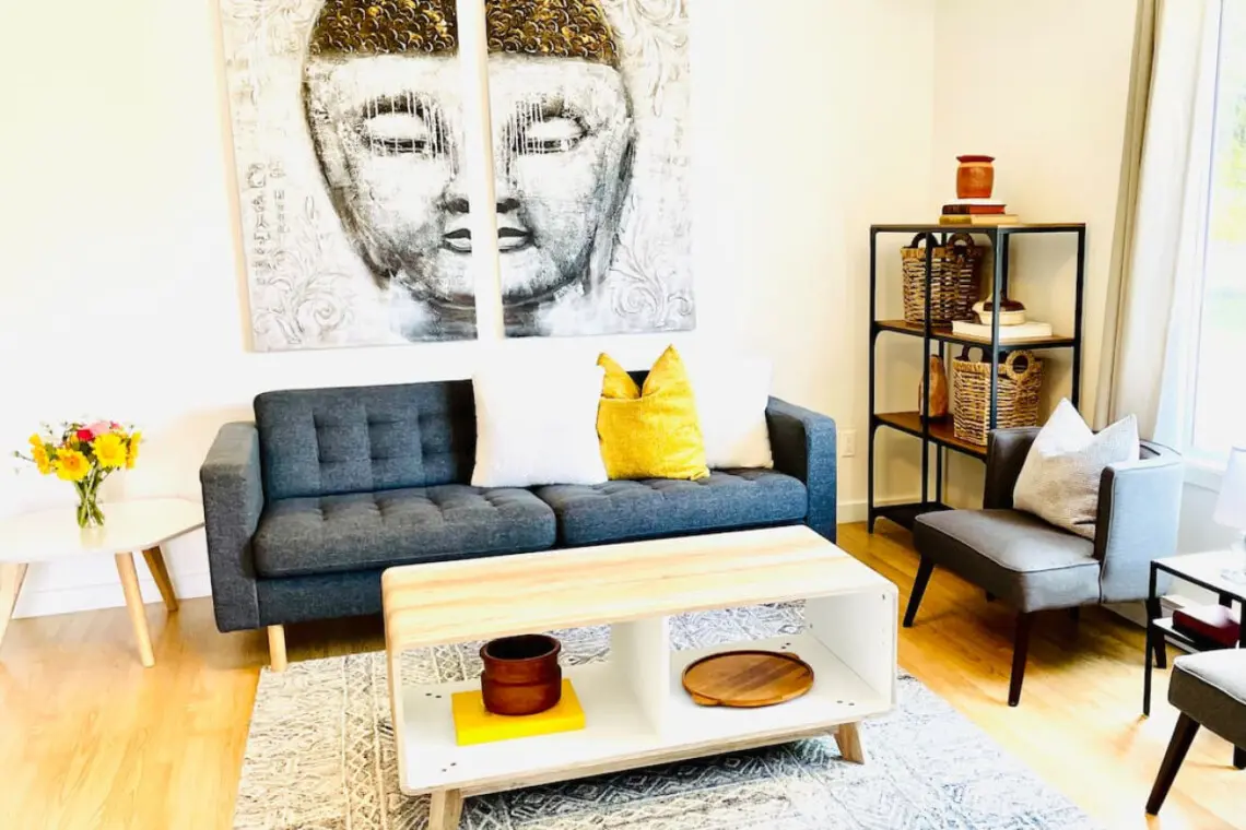 Inviting living room featuring a comfortable sofa, stylish accent chairs, and serene artwork, creating a calming atmosphere perfect for relaxation.