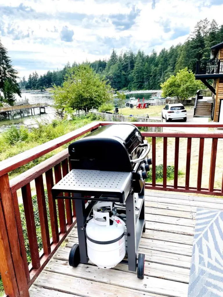 Spacious deck with a gas grill, perfect for outdoor cooking while enjoying scenic views of the surrounding nature.