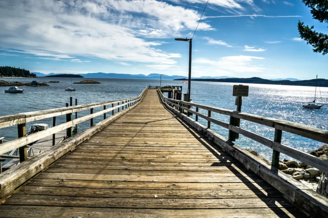 Stunning pier stretching out into the calm waters, offering panoramic views of the horizon and surrounding islands, perfect for peaceful strolls.
