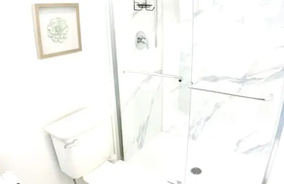 "Bright and airy bathroom with a spacious glass shower, clean lines, and minimalist decor for a refreshing and comfortable experience.