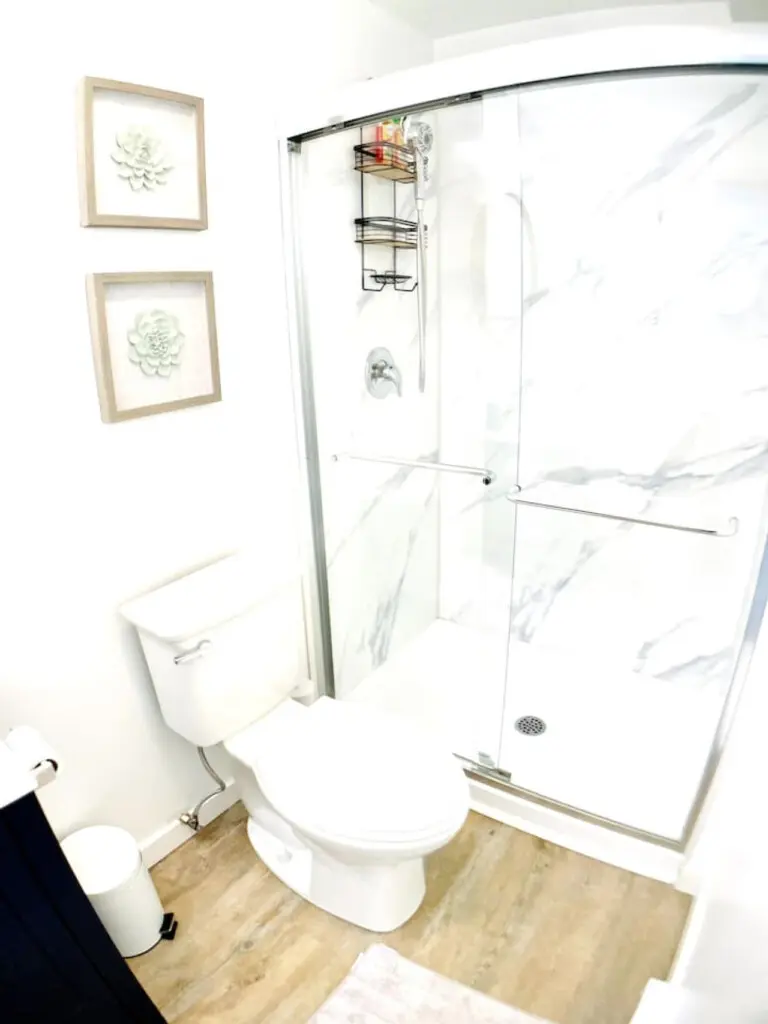 "Bright and airy bathroom with a spacious glass shower, clean lines, and minimalist decor for a refreshing and comfortable experience.