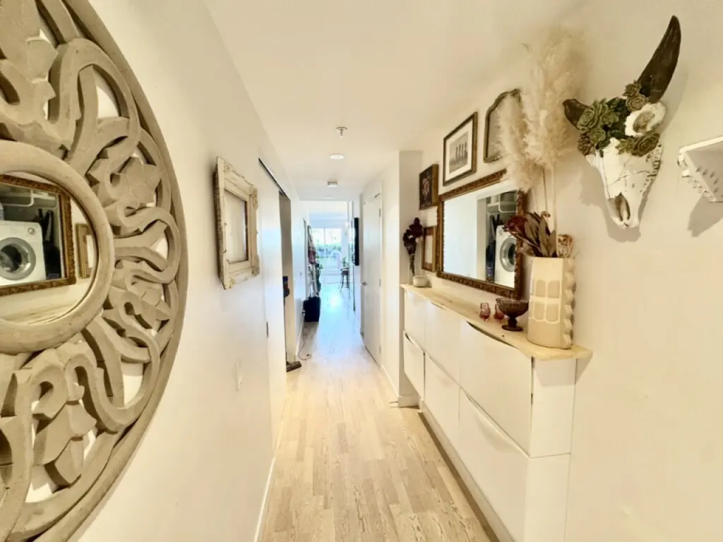 Chic and cozy hallway vibes. Thoughtfully decorated with mirrors, art, and natural textures—making every step feel like home.