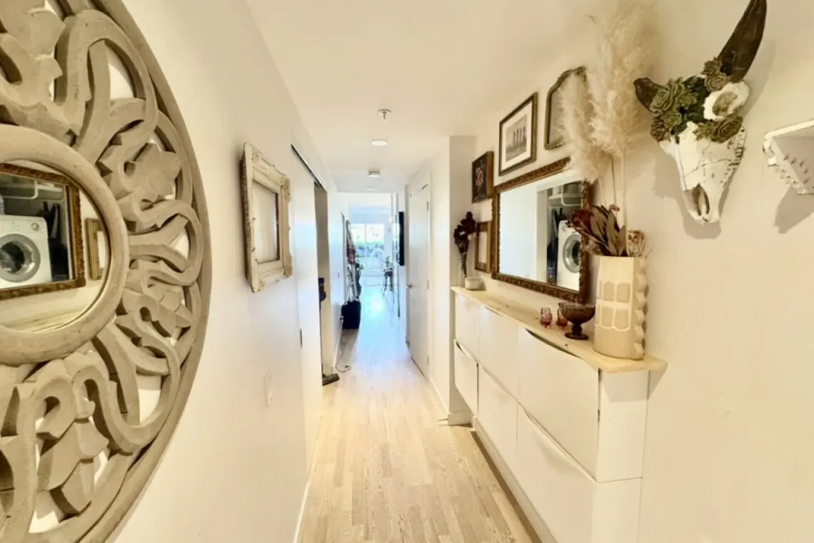 Chic and cozy hallway vibes. Thoughtfully decorated with mirrors, art, and natural textures—making every step feel like home.